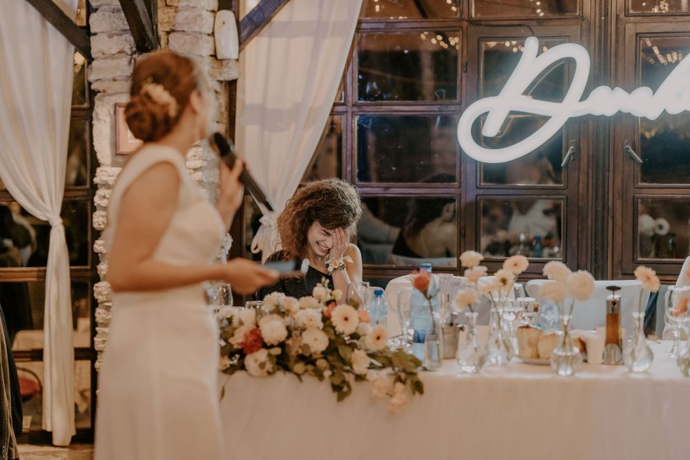 Elegant wedding reception tables decorated with floral arrangements and soft lighting.