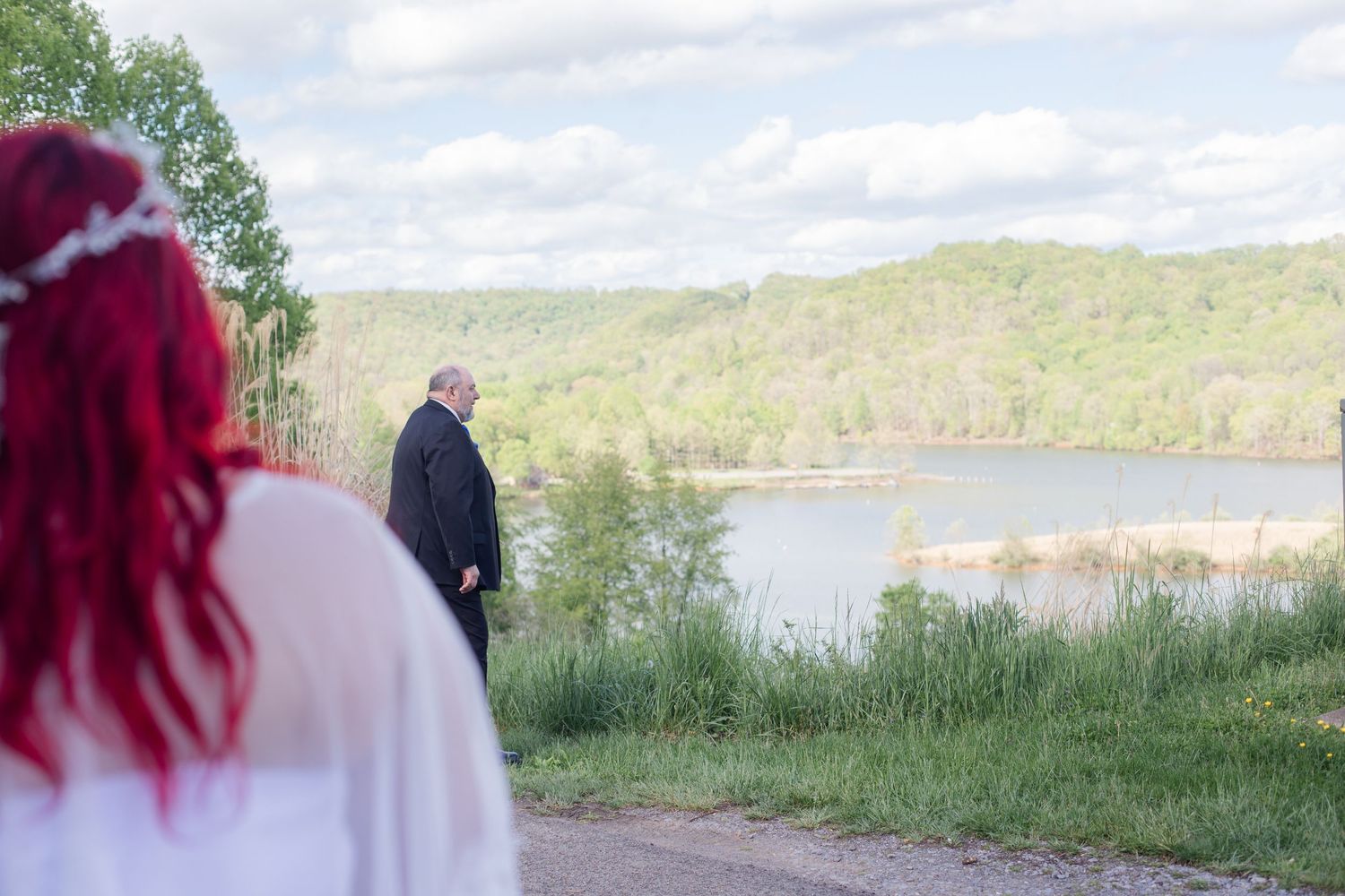 Scenic lakeside wedding ceremony with mountains and trees in the background.