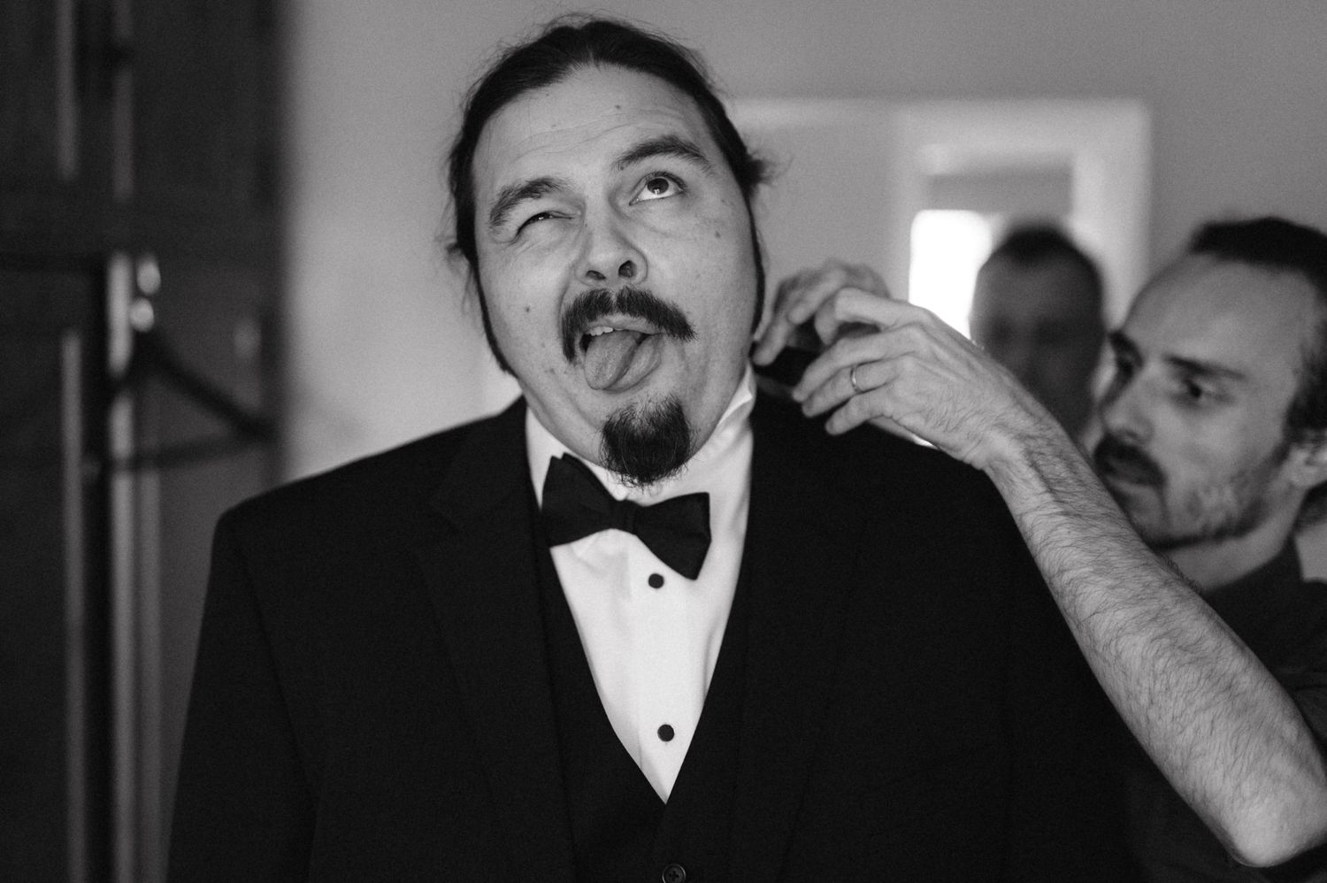 Black and white portrait of someone in formal attire getting ready.