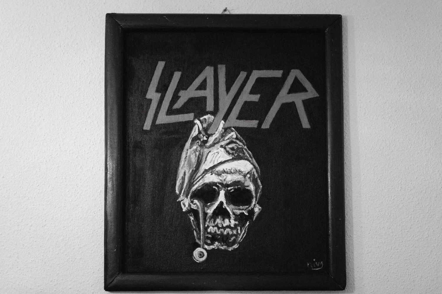 Black framed artwork featuring the Slayer band logo with a skull design.