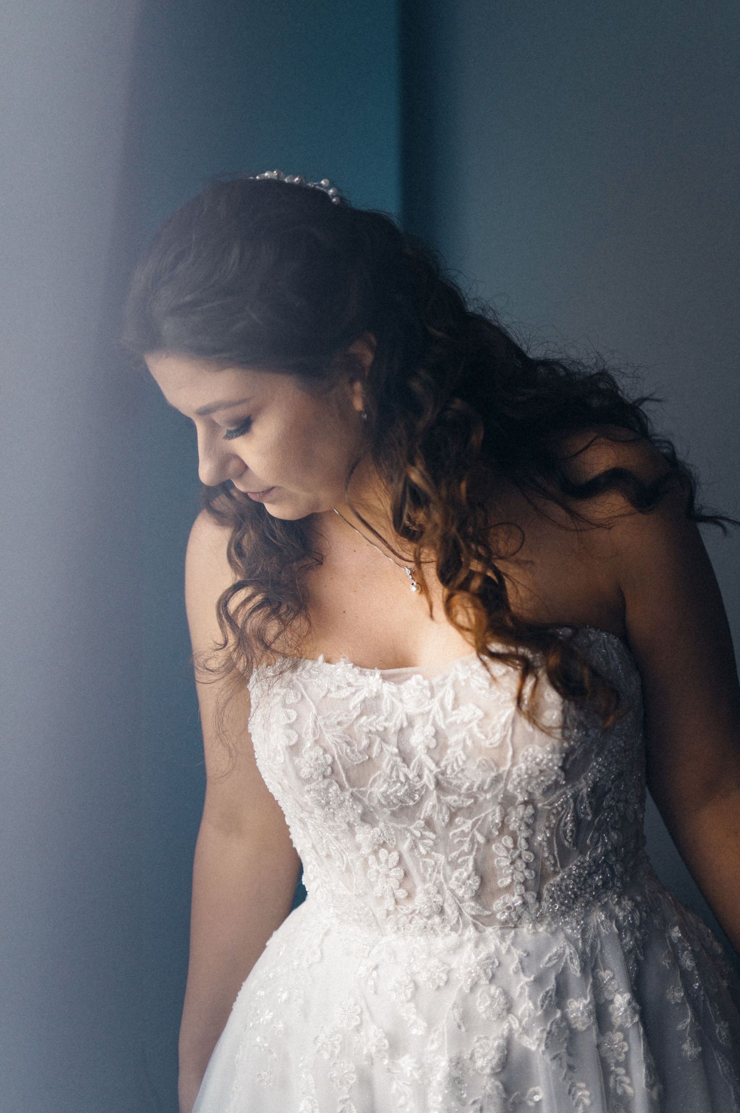 Elegant bridal portrait showing intricate lace details of a strapless wedding gown.
