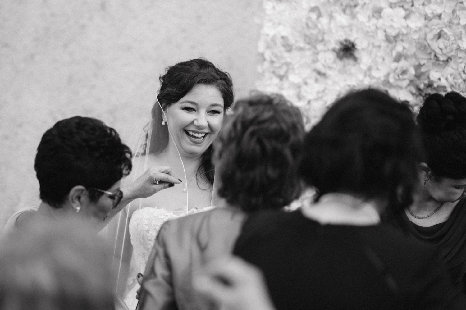A wedding celebration with floral decorations and guests gathered around.