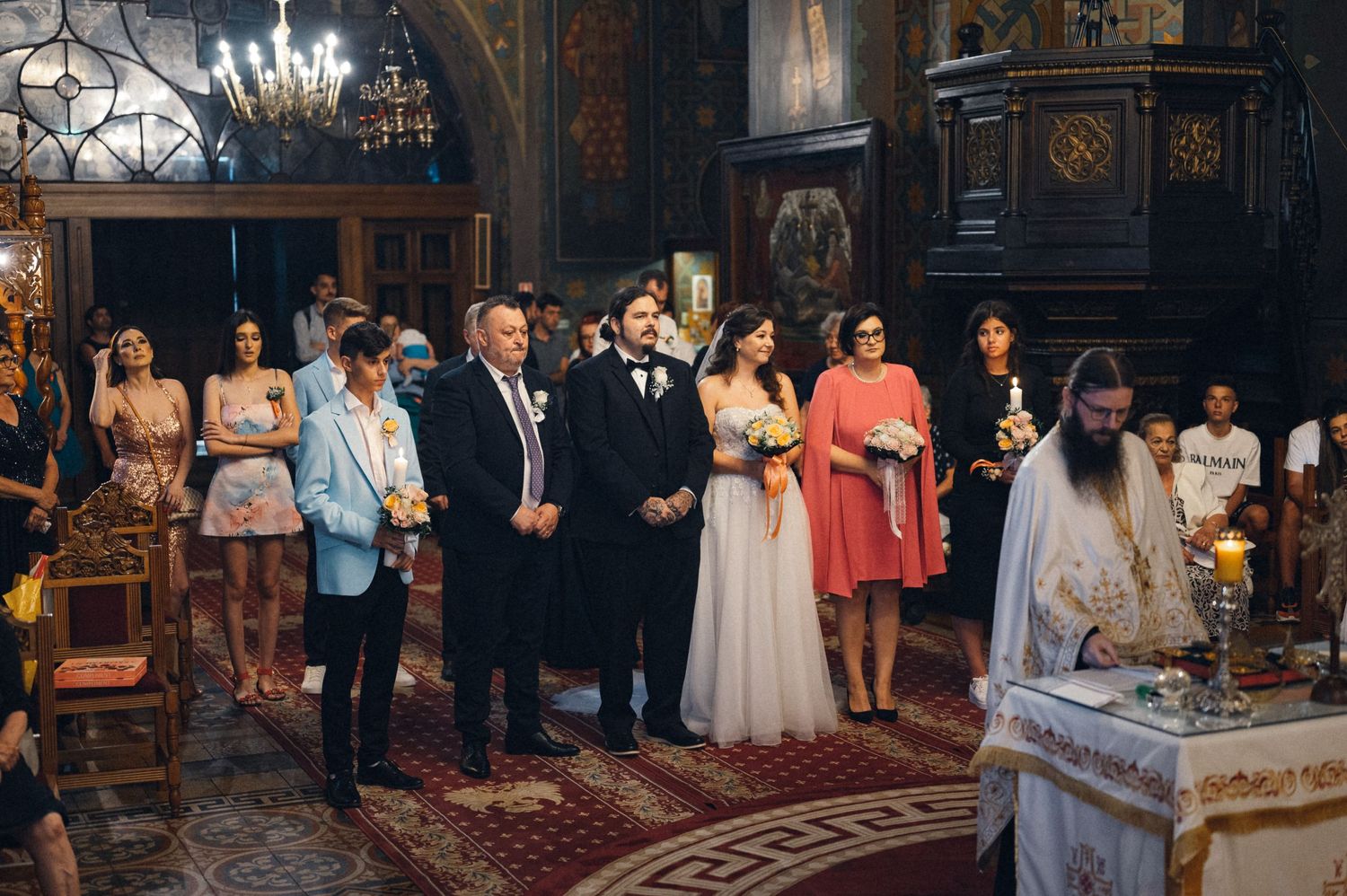 Wedding ceremony in ornate church with guests gathered for traditional service.