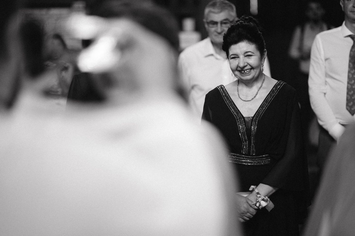 Black and white photo of attendees during a formal church ceremony.