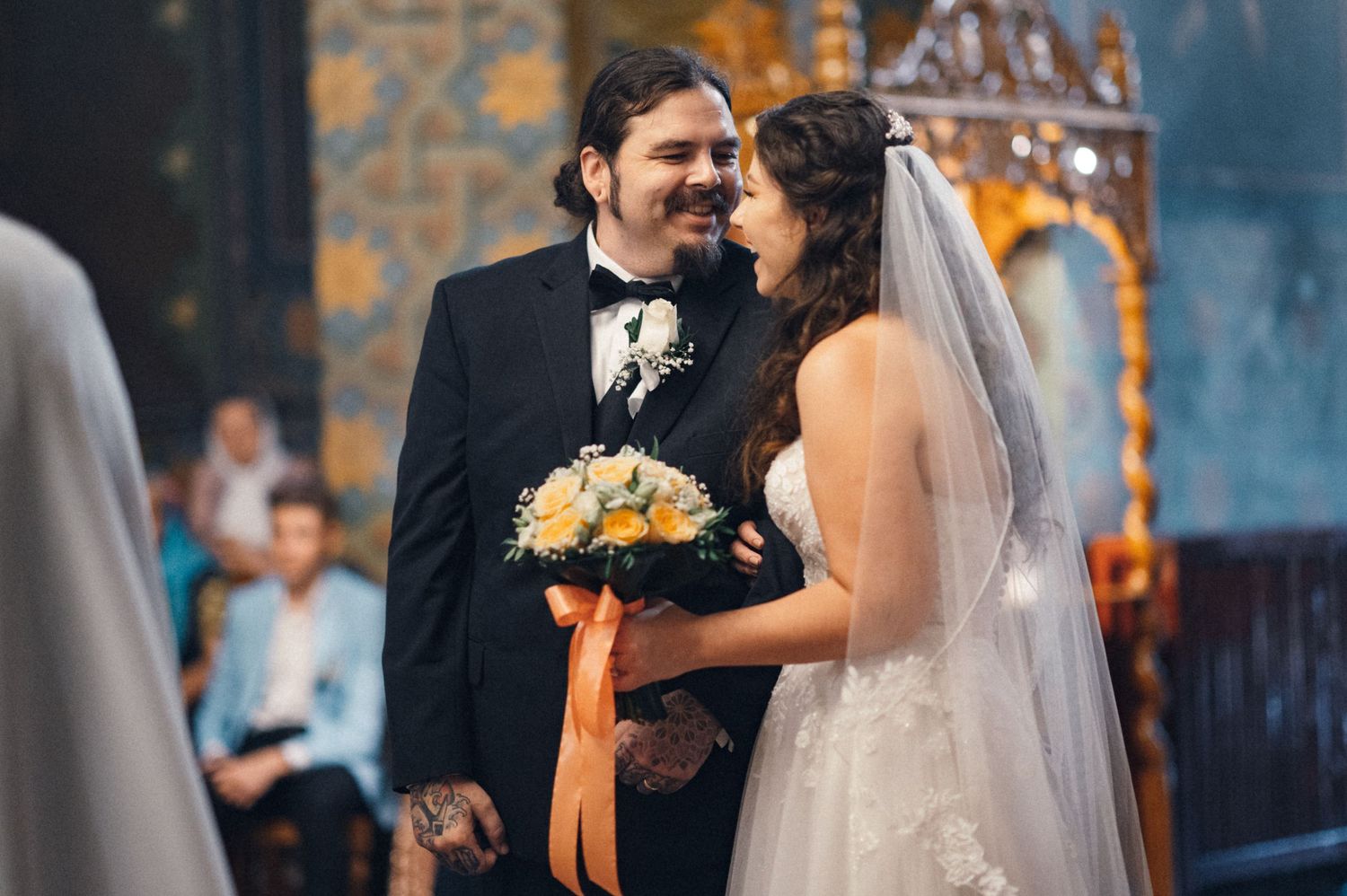 A joyful wedding ceremony in progress inside an ornately decorated church.