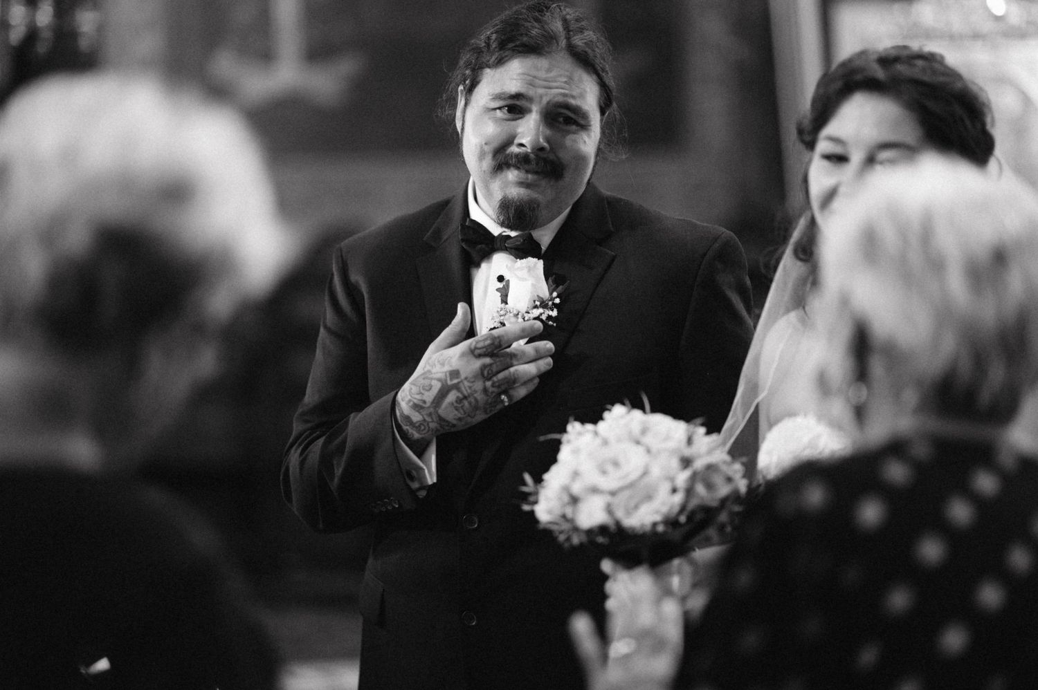 Black and white photograph of a speaker addressing guests during a wedding ceremony.