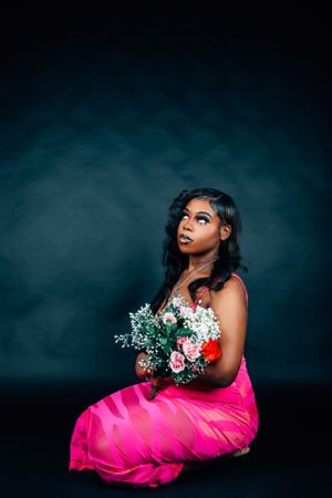 Artistic portrait series with model in vibrant pink dress holding floral arrangement.