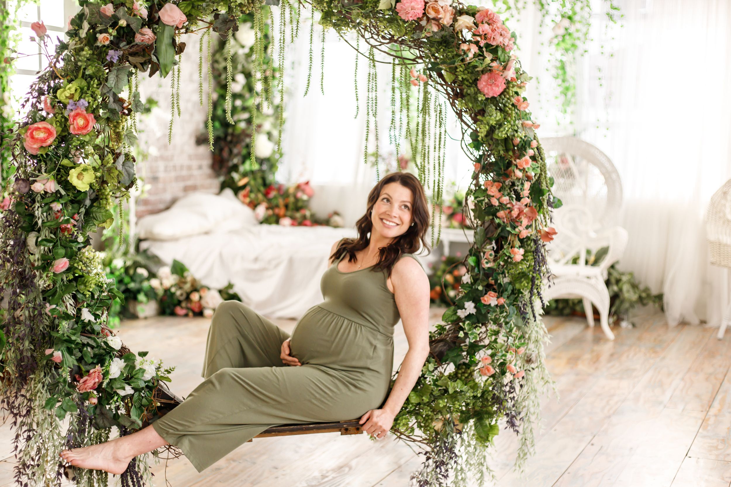 angelic maternity portraits featuring a floral swing