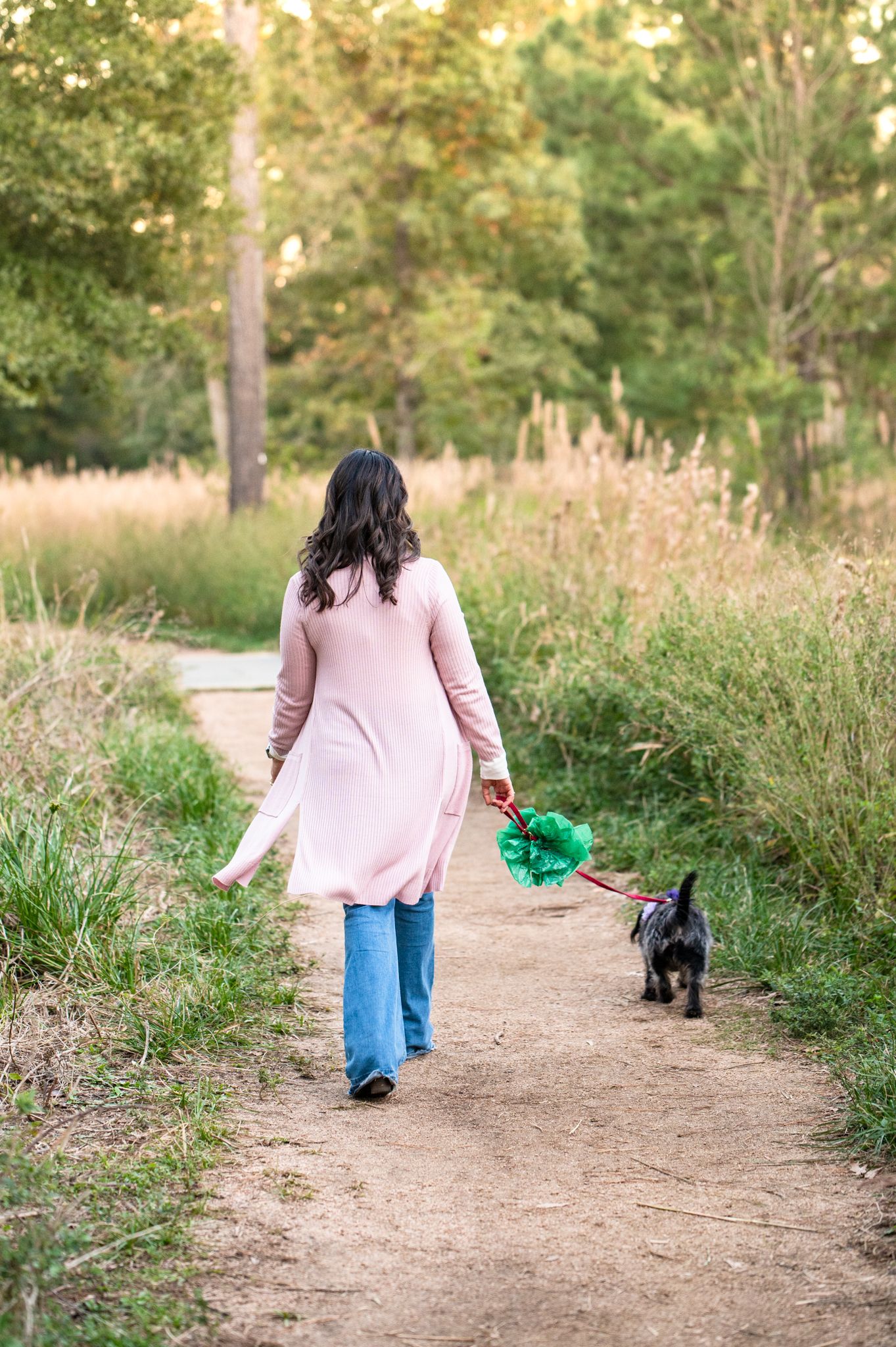woman walking her dog in the houston arboretum