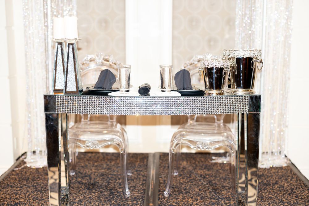 Modern mirrored bar setup with crystal glassware and elegant decor elements.