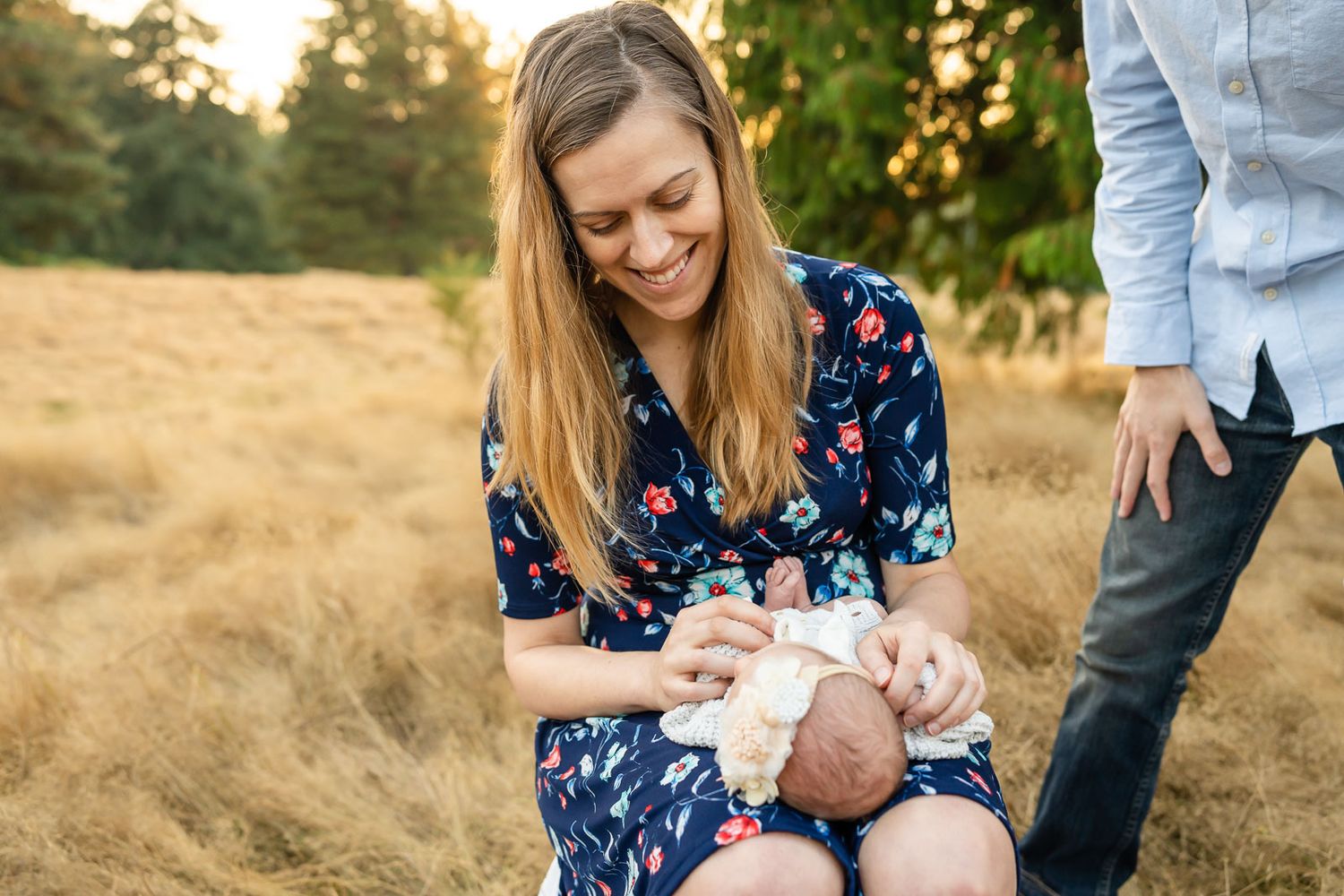 Mother lovingly looks at newborn daughter
