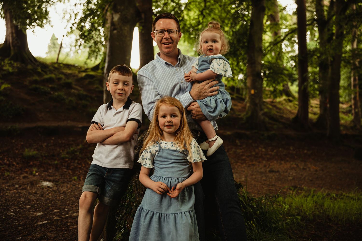 Father with three children in the woods