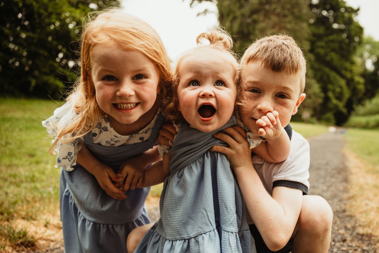 Three siblings smiling