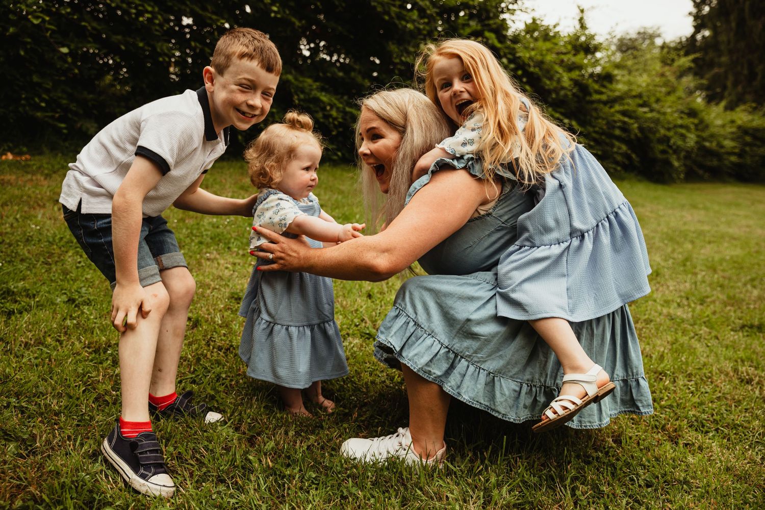 Mother playing with three children