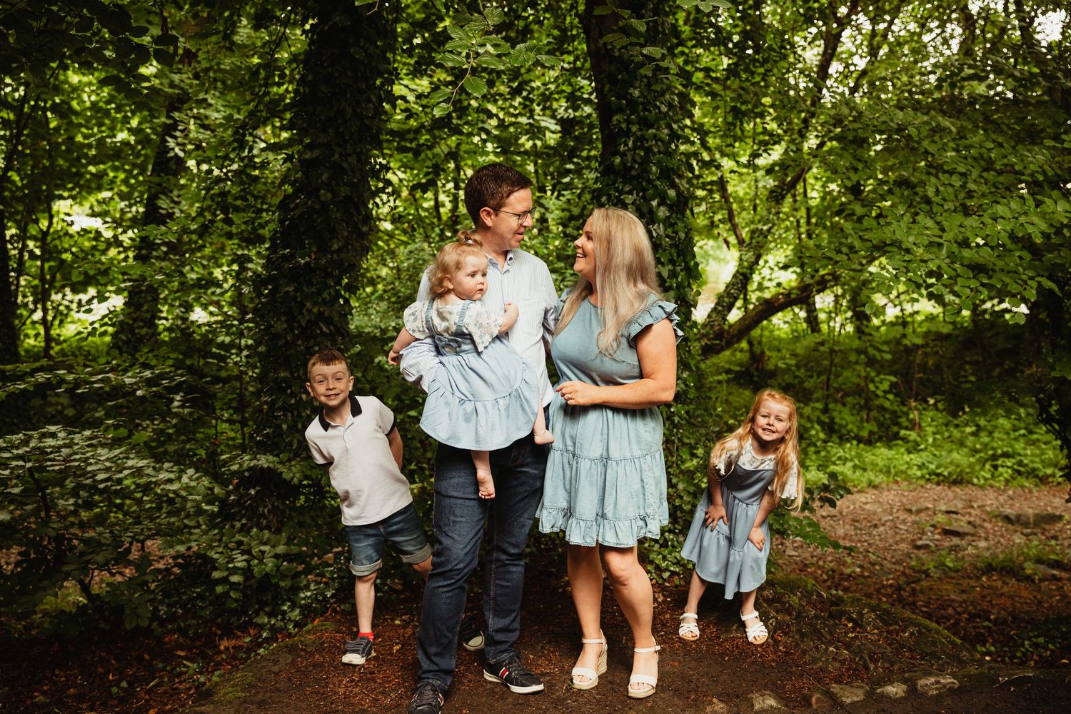 Mother, Father and three children in woods