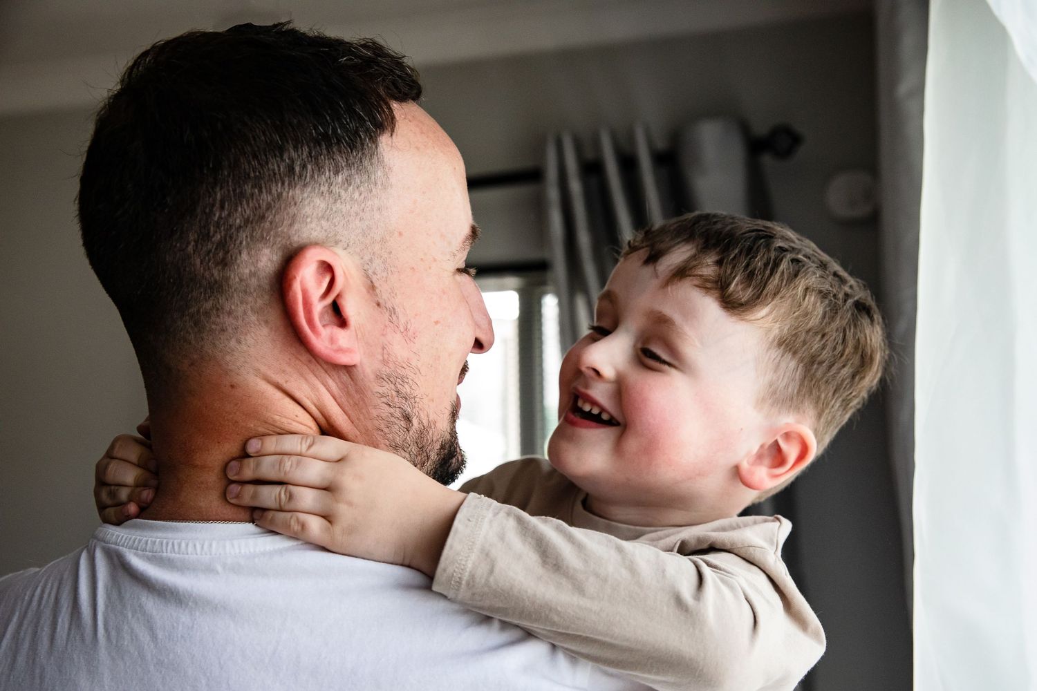 Father and son smiling at each other