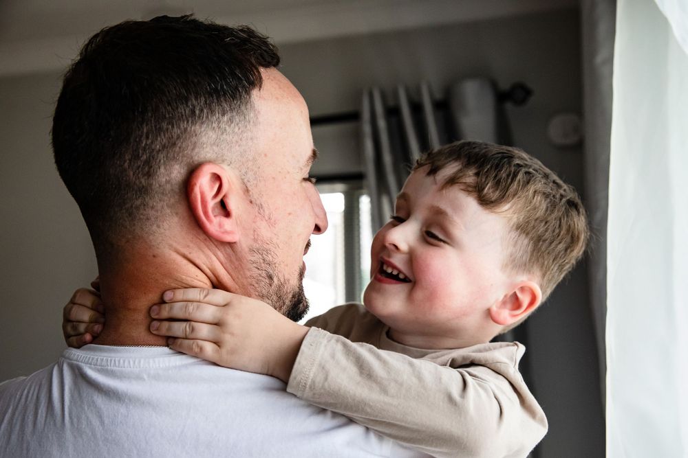 Father and son smiling at each other