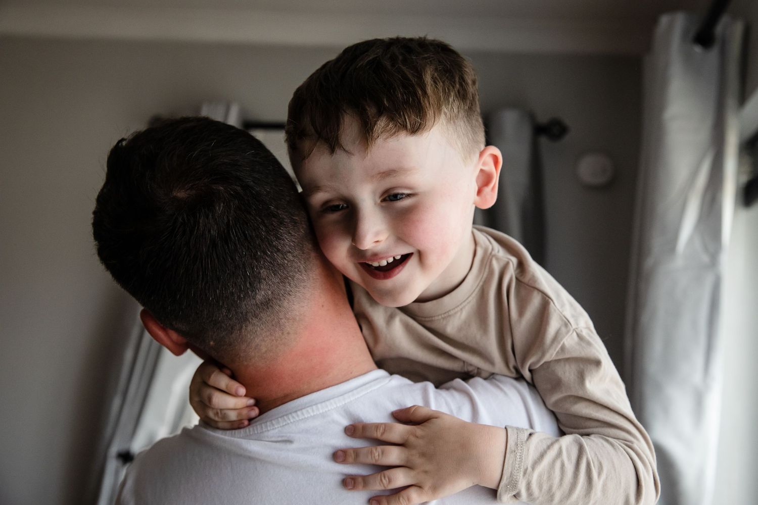 Son looks over father's shoulder