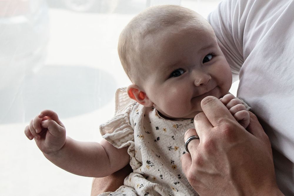 Baby girl smiles at camera