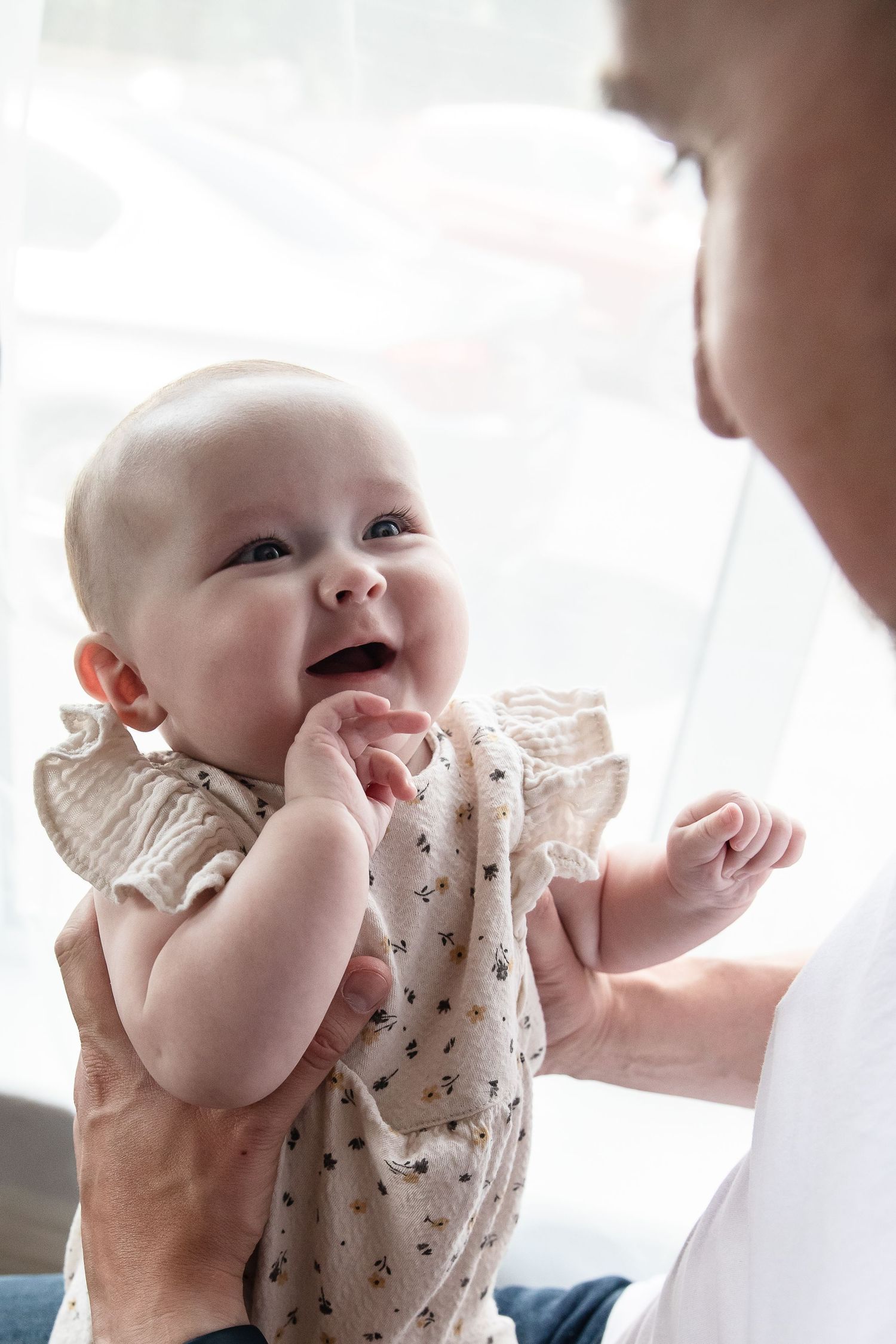Baby girl smiles at father