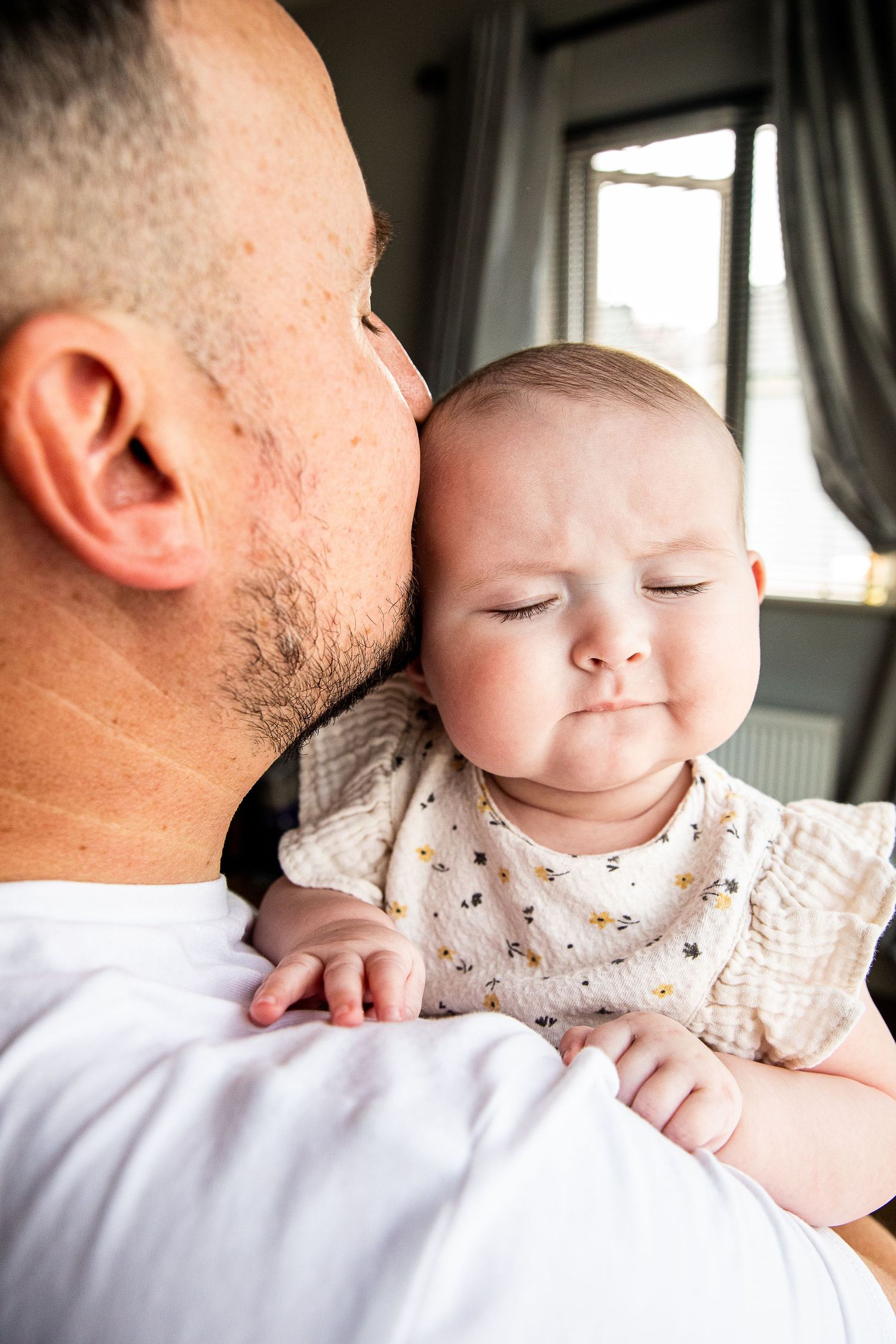 Baby girl and father share a tender moment