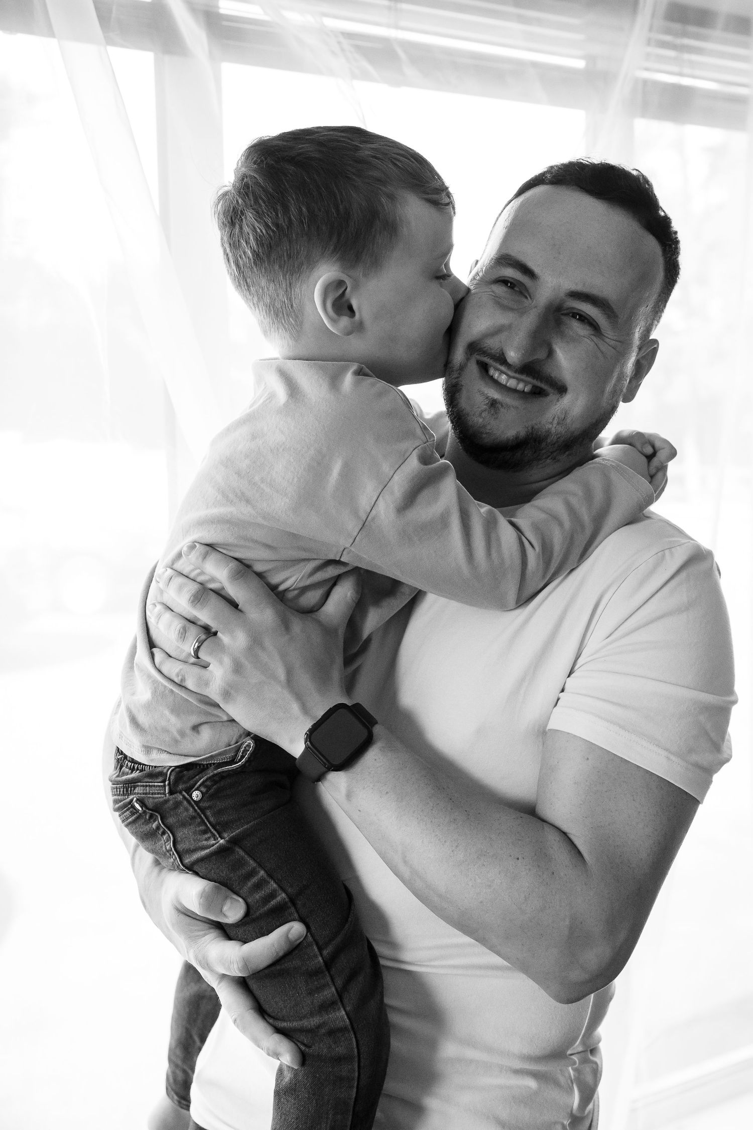 Father and son share a loving moment. Black and White