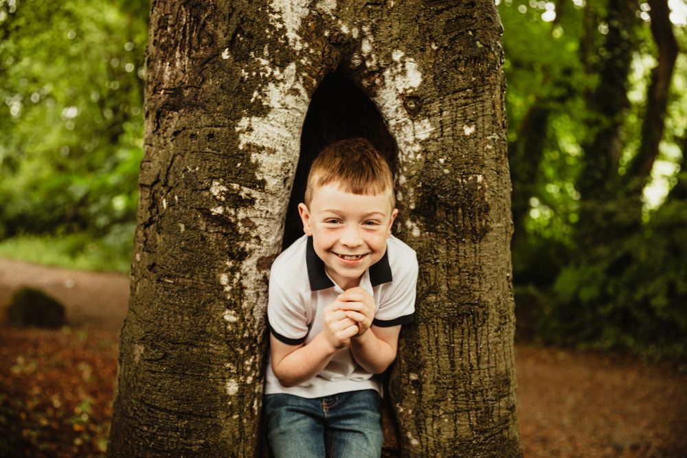 Little boy playing in woods