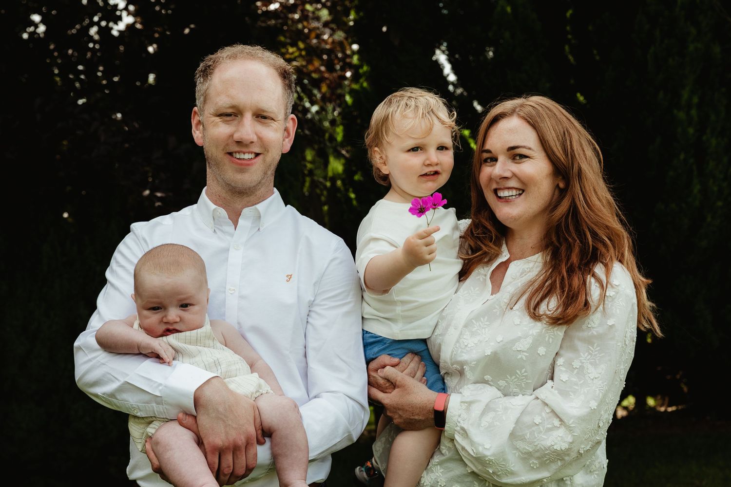 Mother, Father, Toddler and Baby smiling