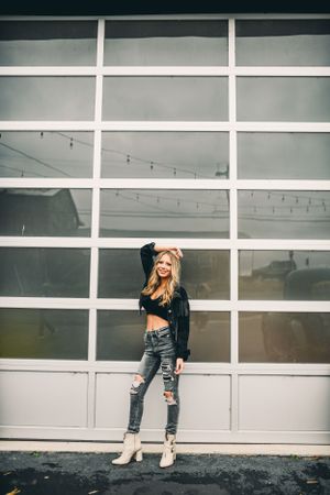 Modern architectural backdrop with white paneled wall and moody lighting.