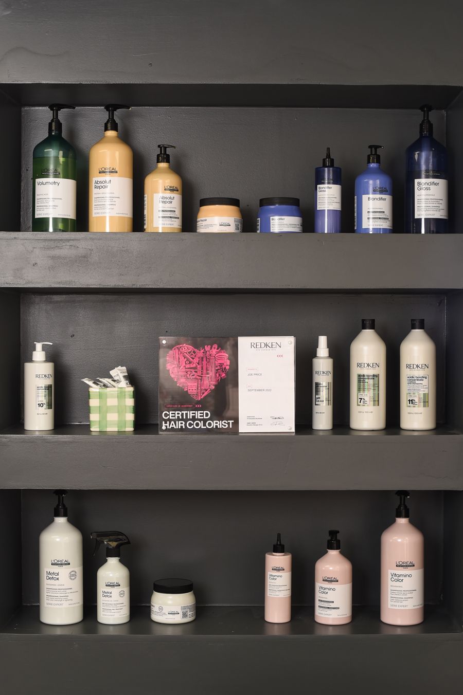 An assortment of hair care products on a shelf, showcased in a branding photoshoot by Abigail's Studio, located in Buckinghamshire.