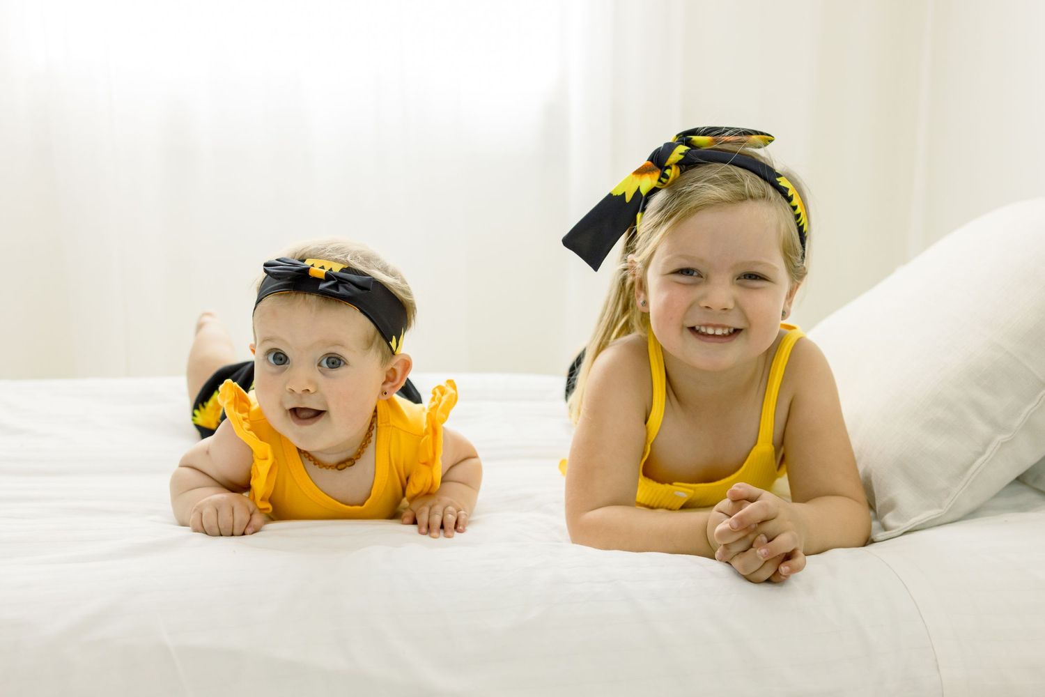 Two siblings during family portrait session in Centurion with natural, joyful style and coordinated outfits