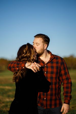 Husband kissing wife's forehead