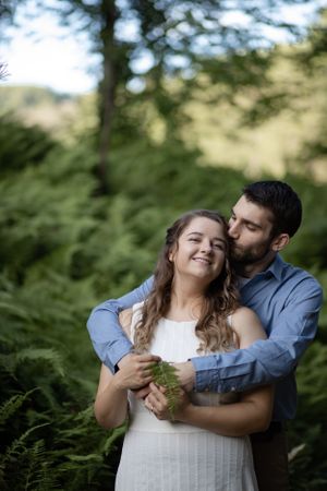 Engaged couple snuggle at engagement photoshoot