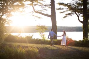 Man leading woman at sunset during engagement photoshoot