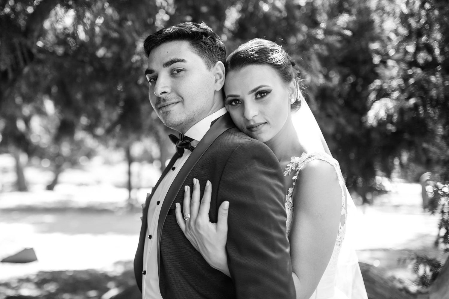 Classic black and white portrait of newlyweds in formal attire.