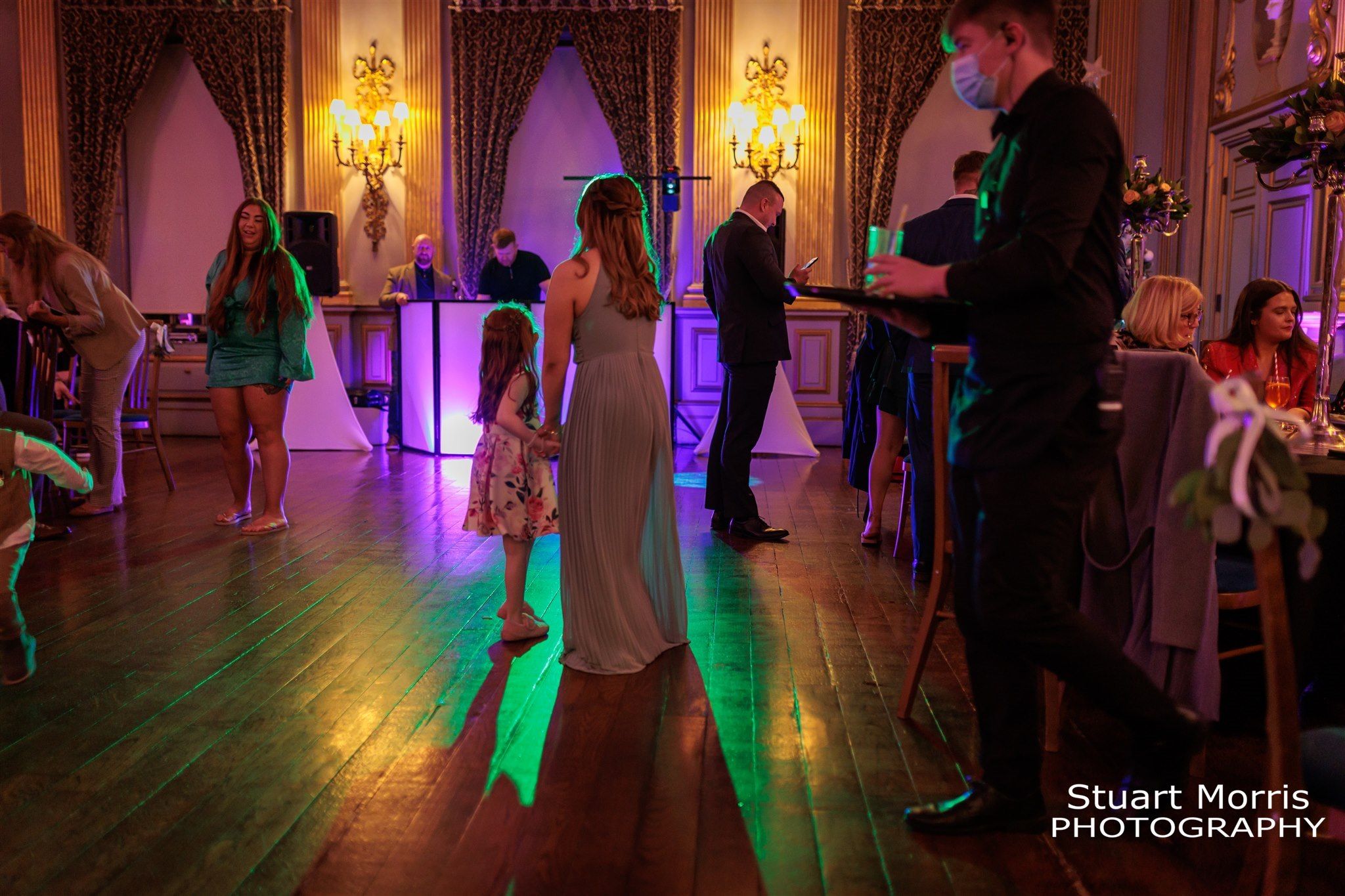 Wedding guests join the bride and groom on the dancefloor. Knowsley Hall wedding photographer. Liverpool wedding venue.