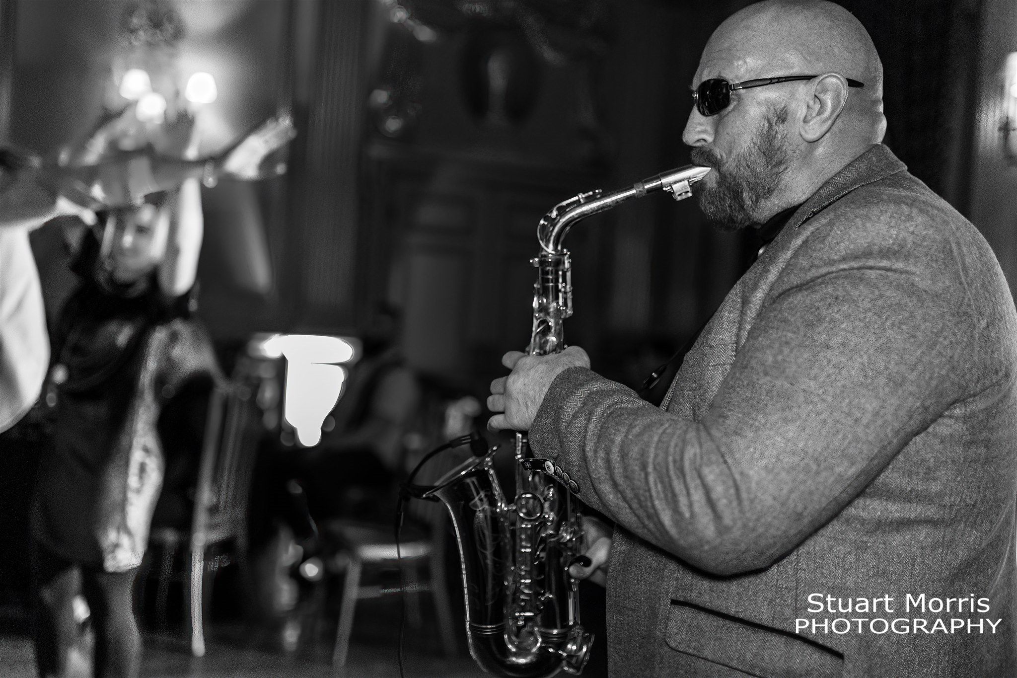 Saxophonist plays for the wedding guests at Knowsley hall Liverpool stately home and wedding venue.