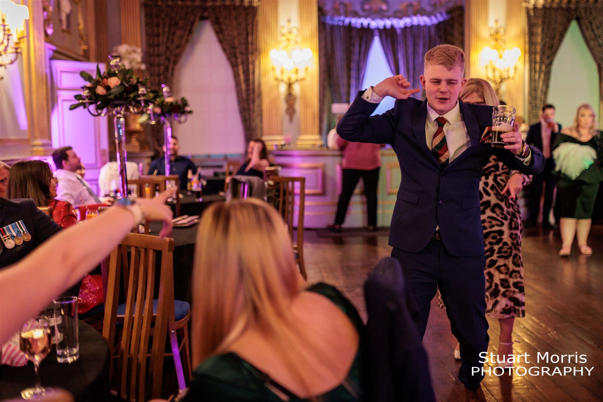 Male wedding guests throwing shapes on his own on the Knowsley hall dancefloor.