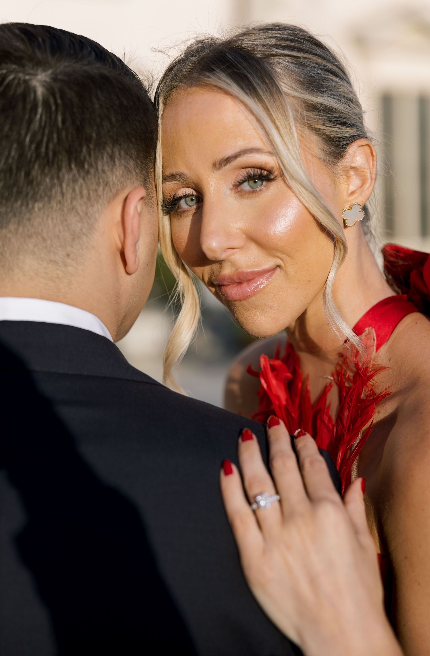 Romantic close-up moment between couple in formal attire.