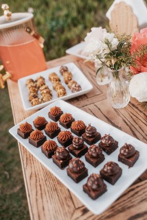 Chocolate dessert display featuring artisanal truffles and treats on rustic wooden tables.