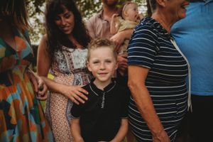 Close-up of family members during a casual outdoor gathering.