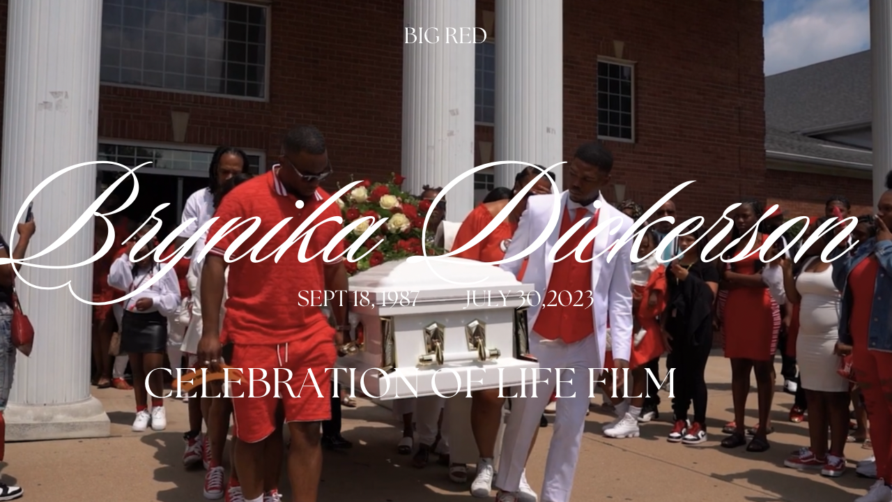 People gathered outside a brick building with columns for a wedding celebration film shoot.