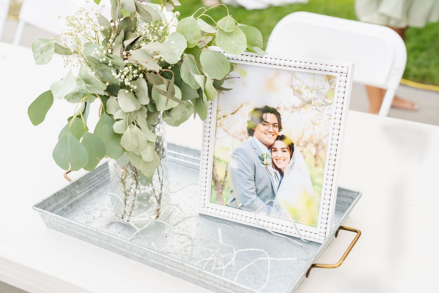 Light and airy photo of a wedding photo displayed at the wedding reception in Highland, Utah.