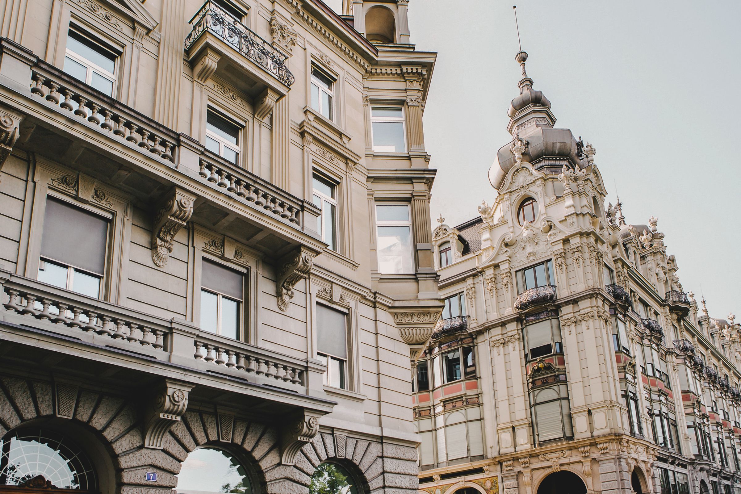 Low-angle architectural shot of a grand historic building in Zurich with ornate stone details.