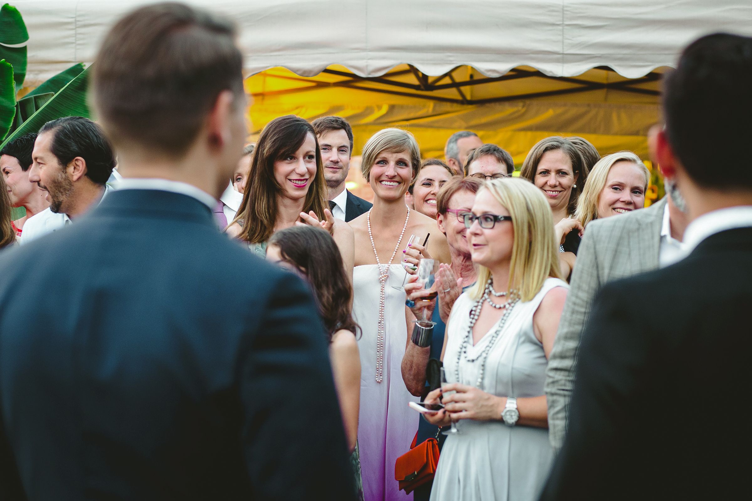 A woman stand before a captivated crowd, embodying a moment of engagement and interaction with the audience.