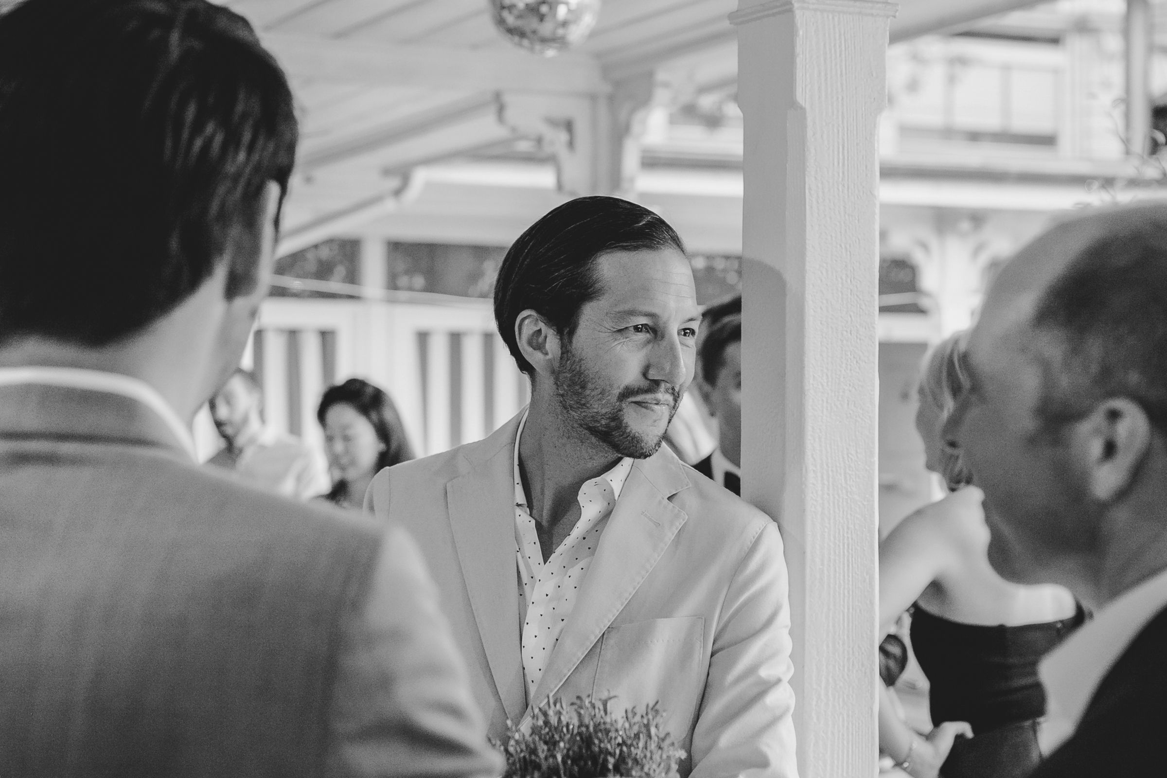 A black and white photo showcasing a man, highlighting their expressions and the atmosphere of the moment.