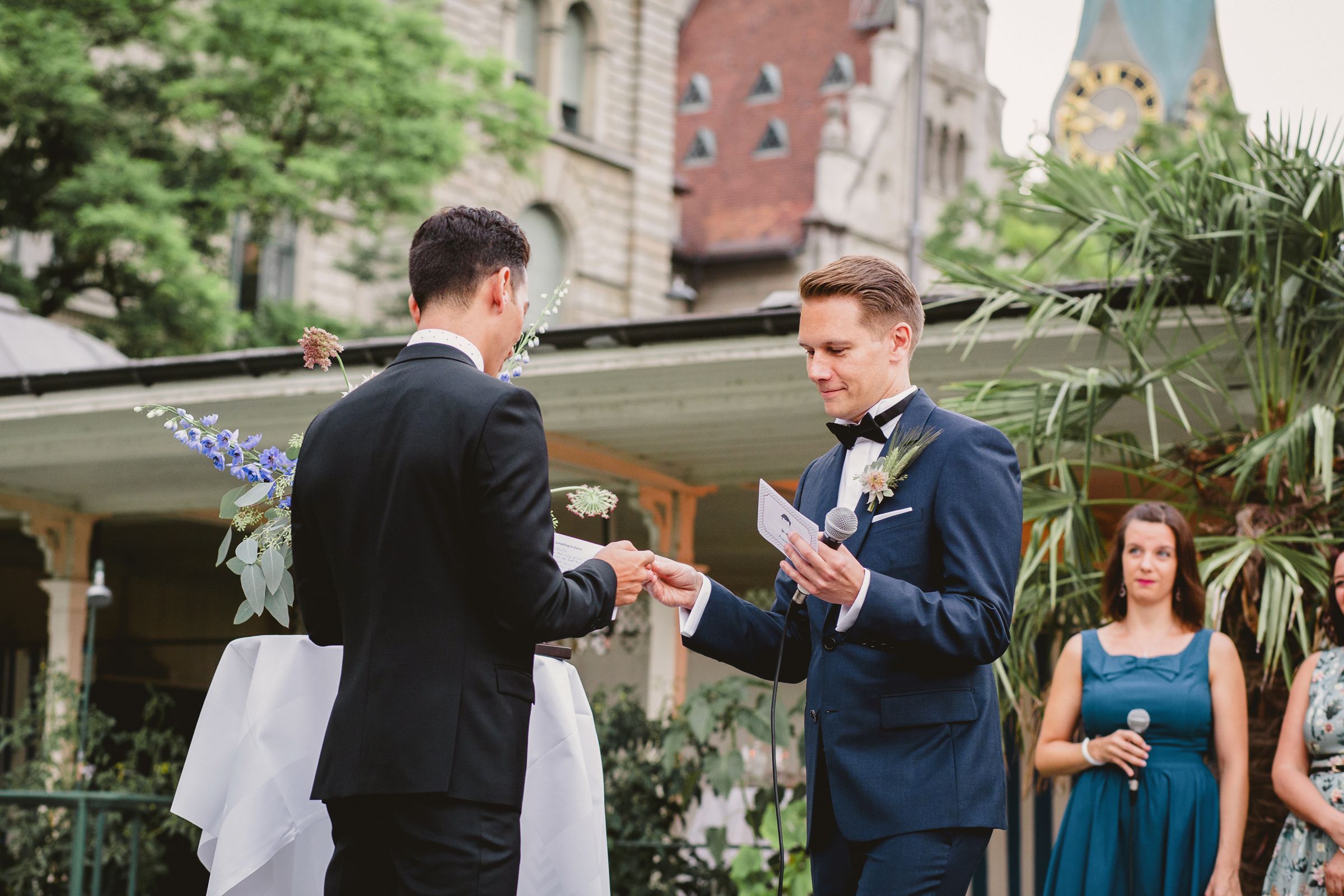 A gay couple exchanging rings at wedding