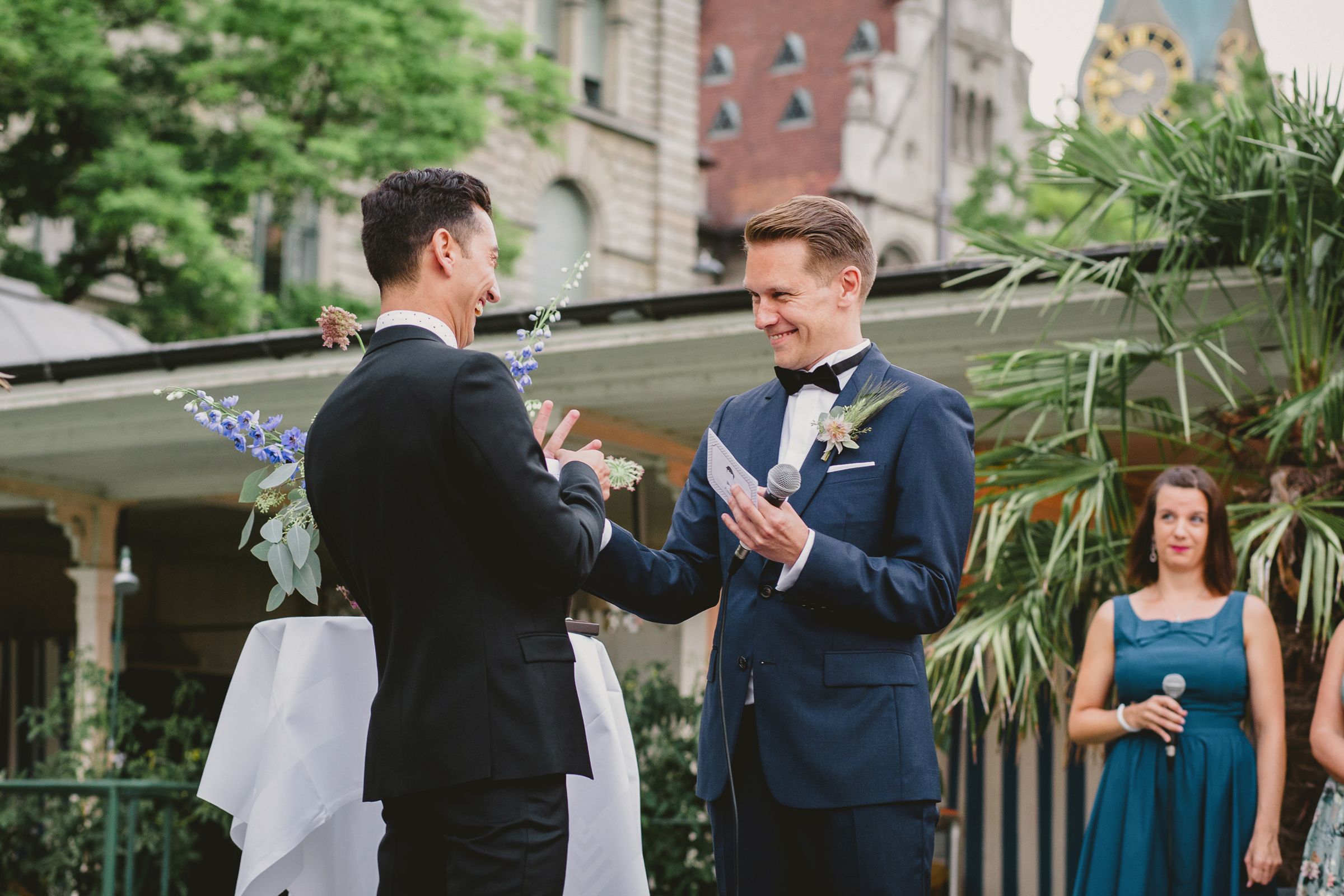 A gay couple exchanging rings at wedding