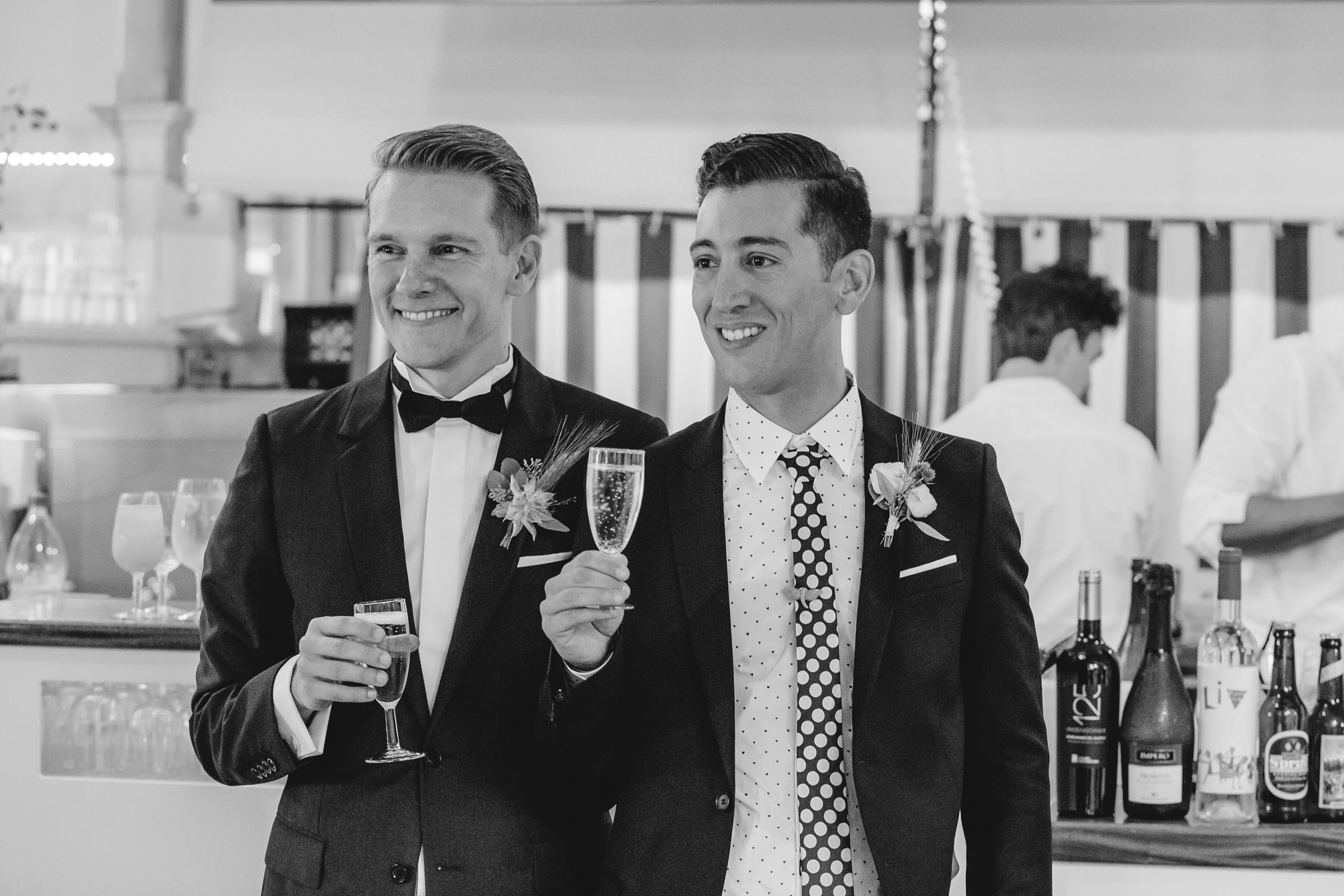A happy gay couple propose a Toast
