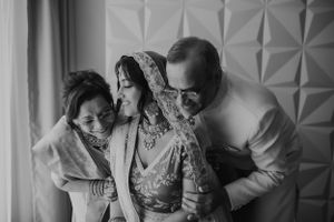 Emotional black and white candid moment during wedding preparations.